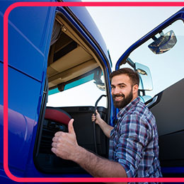 A man standing in front of a large truck with a commercial license class